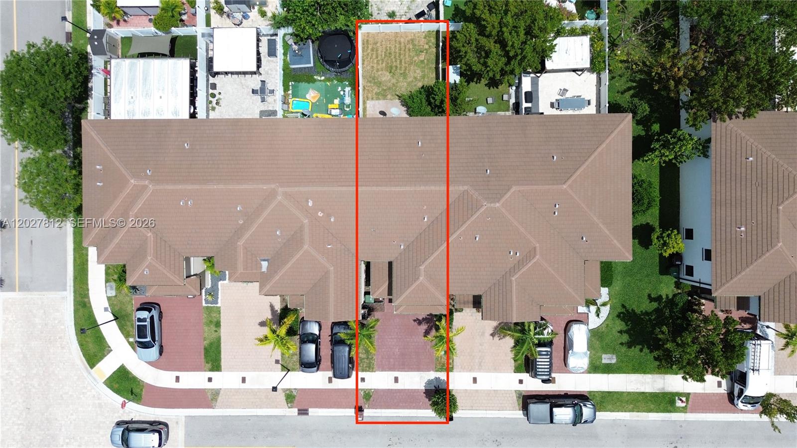 This aerial view shows a townhouse unit with a private driveway and a backyard — 3342 W 104th Ter, Hialeah FL 33018, HIALEAH, FL
