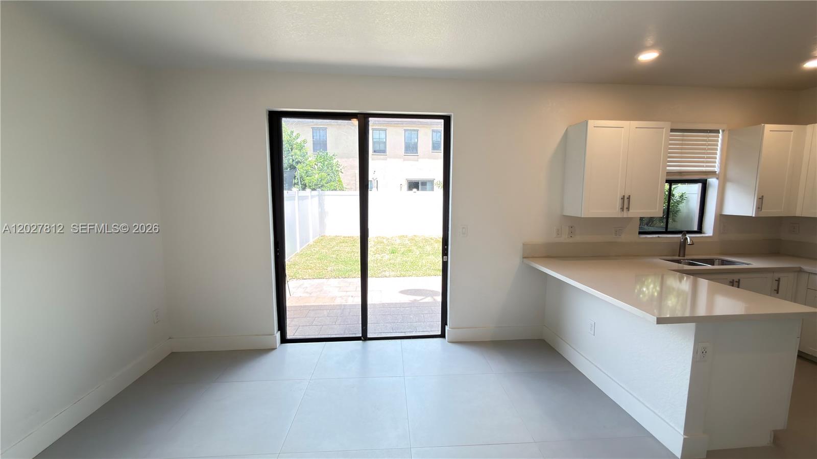 A kitchen features dark wood cabinets, granite countertops, and stainless steel appliances — 3342 W 104th Ter, Hialeah FL 33018, HIALEAH, FL