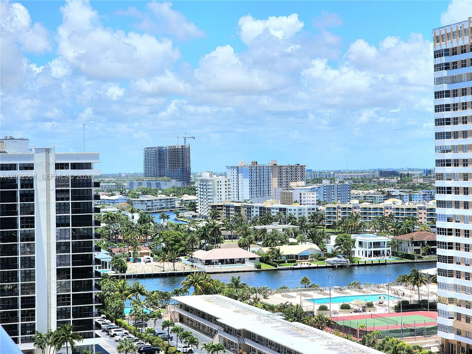 An elevated view shows a canal, residential buildings, a swimming pool, and a tennis court — 2030 S Ocean Dr # 1405, Hallandale Beach FL 33009, HALLANDALE BEACH, FL