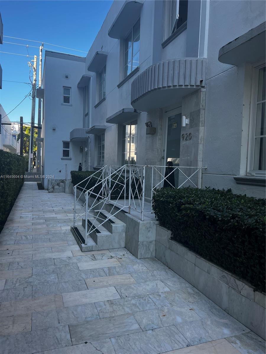 A white multi-story building features a stone walkway, stairs, and a metal railing — 920 Jefferson Ave # 3, Miami Beach FL 33139, MIAMI BEACH, FL
