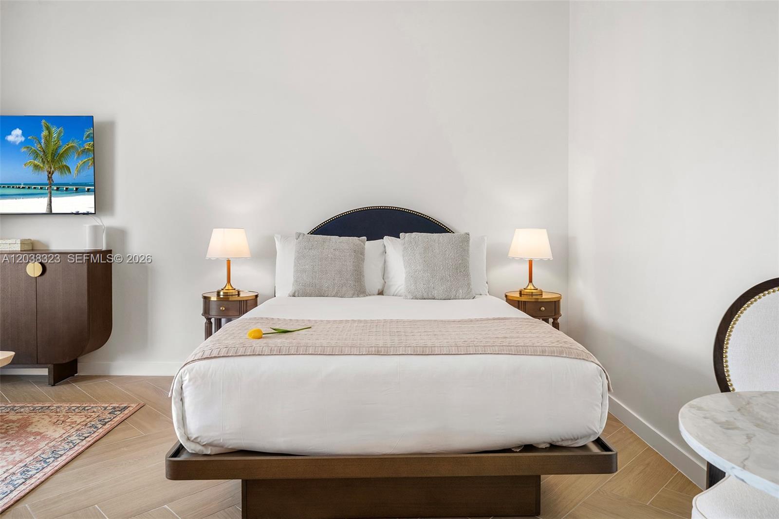 A bedroom features a platform bed with a dark blue headboard and two nightstands — 2700 NW 2nd Ave # 644, Miami FL 33127, MIAMI, FL