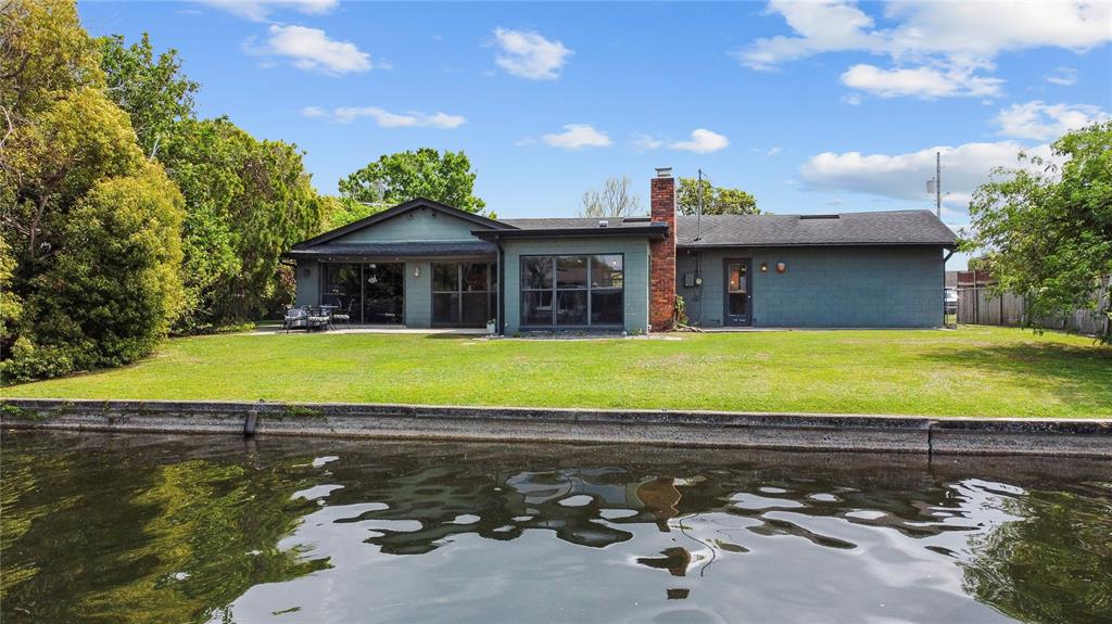 An aerial view shows a residential neighborhood with a canal leading into a large lake — 2601 WINDWARD COURT, ORLANDO, FL