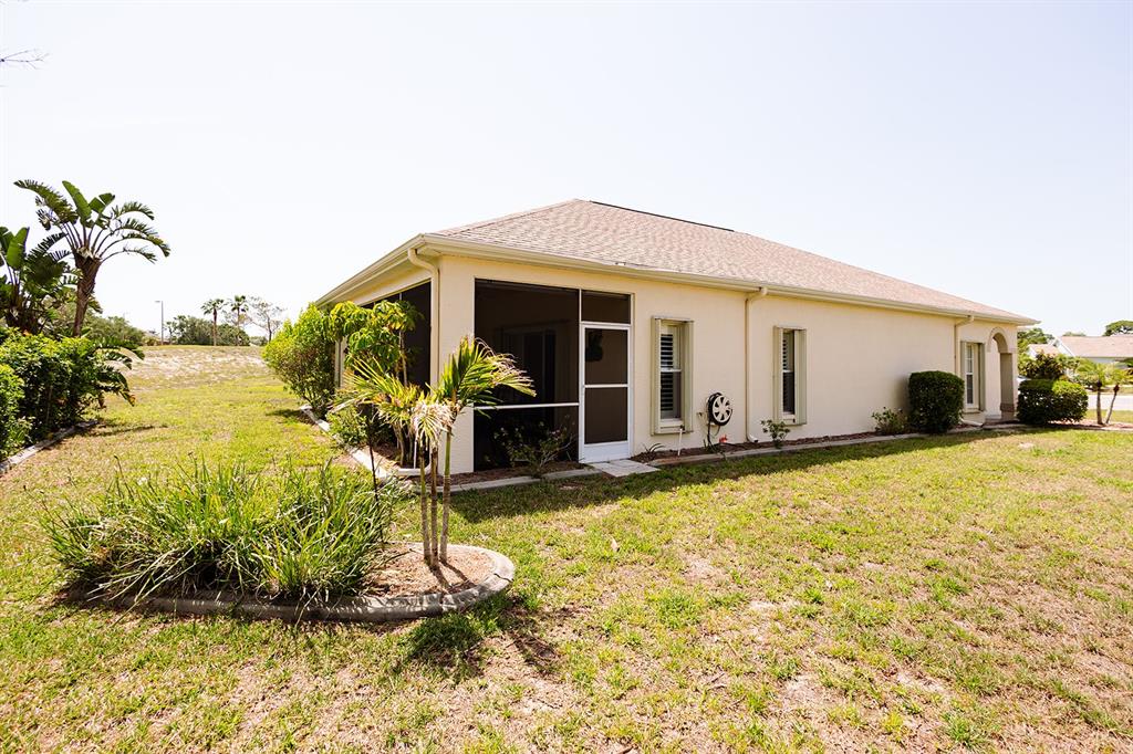 An aerial view of a single-story suburban house with a tan exterior and garage — 2542 SANDY HILL COURT, HOLIDAY, FL