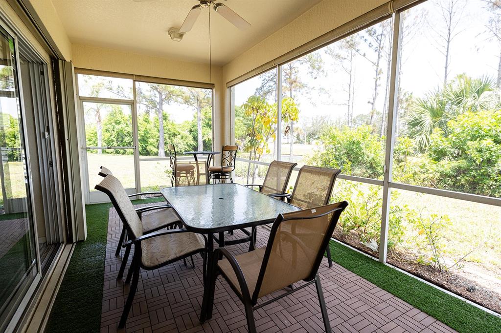 A single-story house with a beige stucco exterior, a two-car garage, and a concrete driveway — 2542 SANDY HILL COURT, HOLIDAY, FL