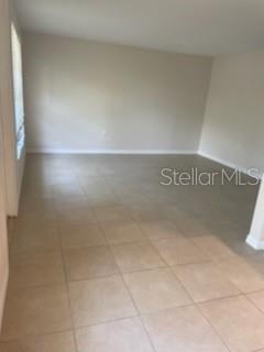 An empty room with beige tile flooring and light-colored walls — 208 MAGNOLIA AVENUE UNIT B, ANNA MARIA, FL