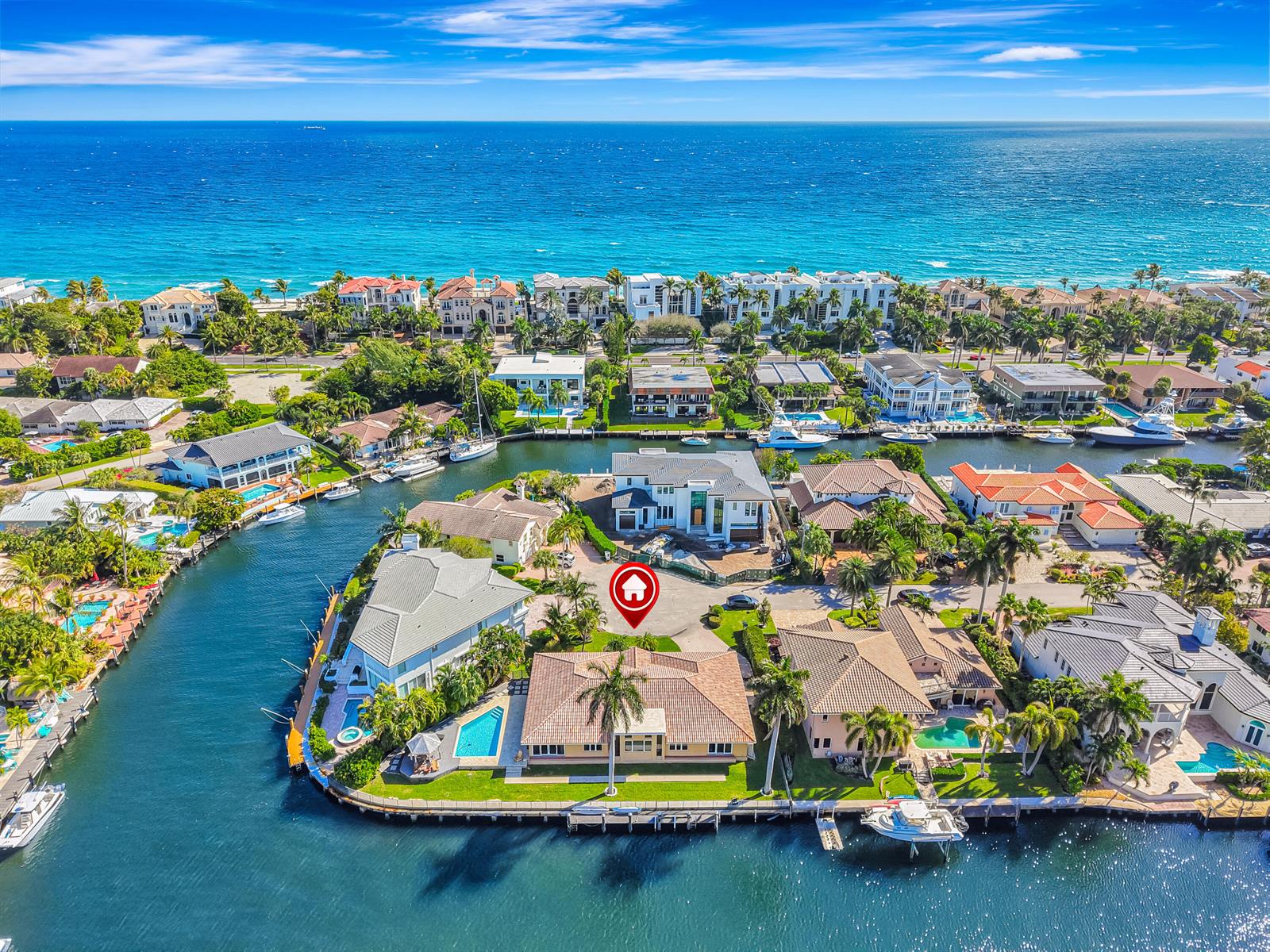 An aerial view shows a waterfront house with a pool and boat dock — 4204 Tranquility Drive, Highland Beach FL 33487, HIGHLAND BEACH, FL