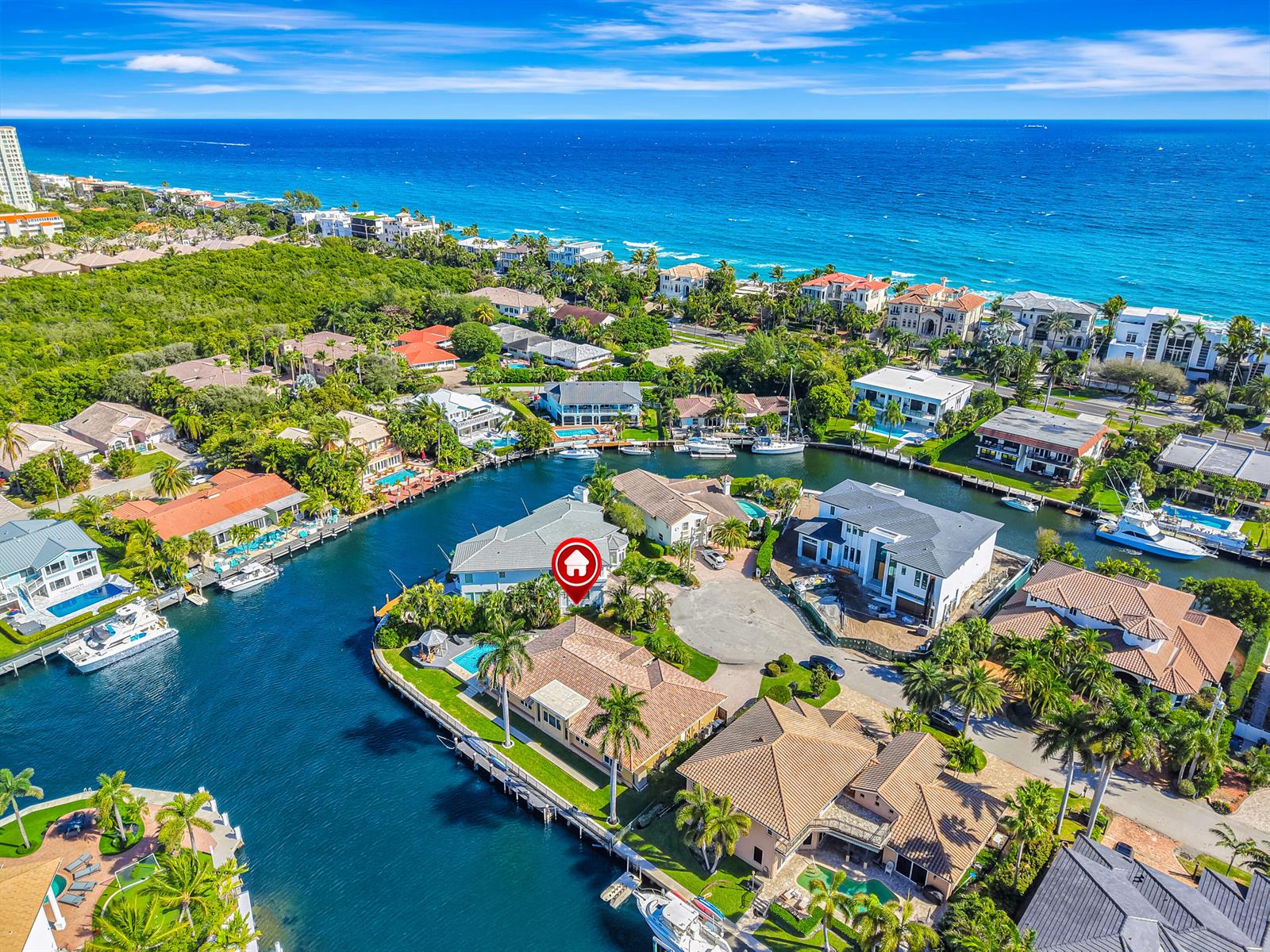 An aerial view shows a waterfront house with a pool located on a canal — 4204 Tranquility Drive, Highland Beach FL 33487, HIGHLAND BEACH, FL