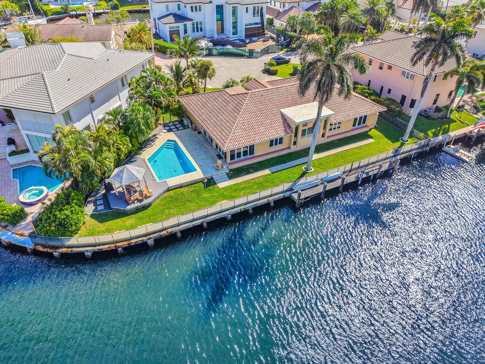An aerial view shows a waterfront house with a pool, gazebo, and private dock — 4204 Tranquility Drive, Highland Beach FL 33487, HIGHLAND BEACH, FL