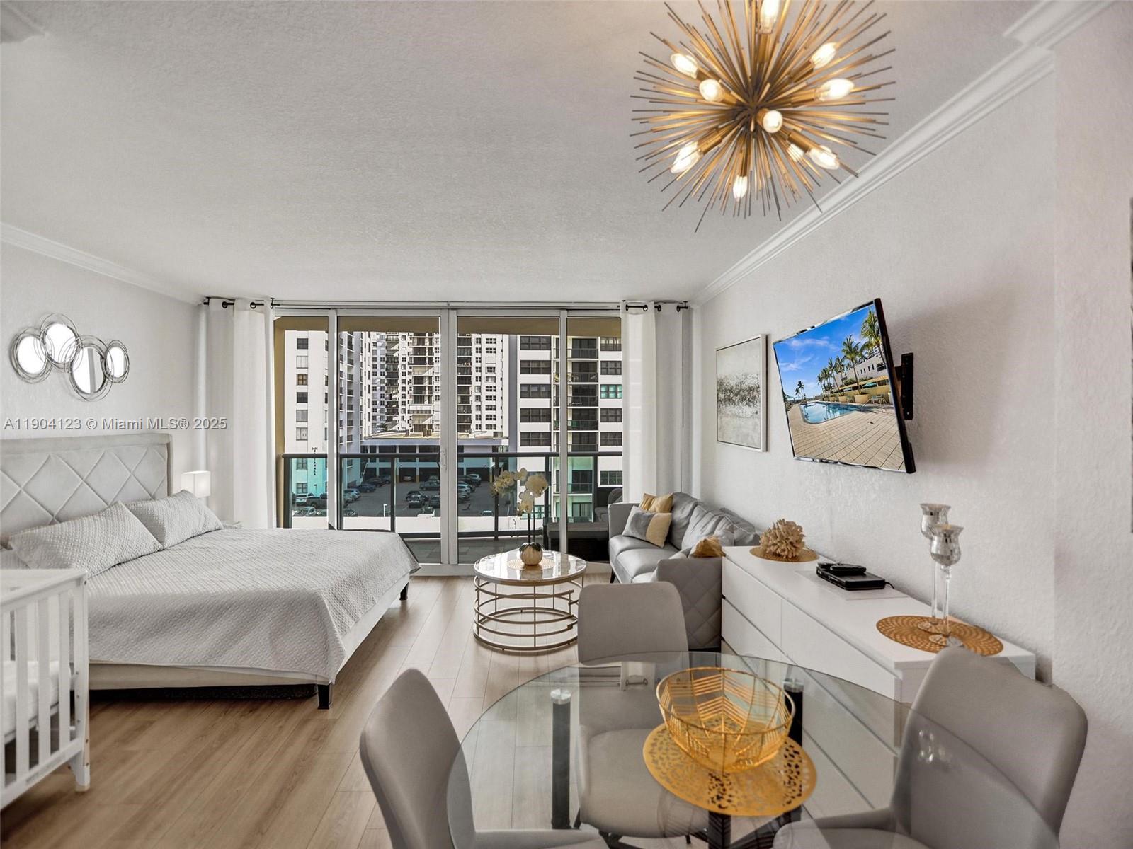 A studio apartment features a bed, living area, dining table, and a balcony with city views — 2501 S Ocean Dr # 505, Hollywood FL 33019, HOLLYWOOD, FL
