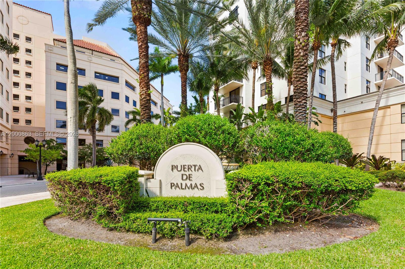 A stone sign reading Puerta de Palmas sits in front of palm trees and buildings — 888 S Douglas Rd, Coral Gables FL 33134, CORAL GABLES, FL