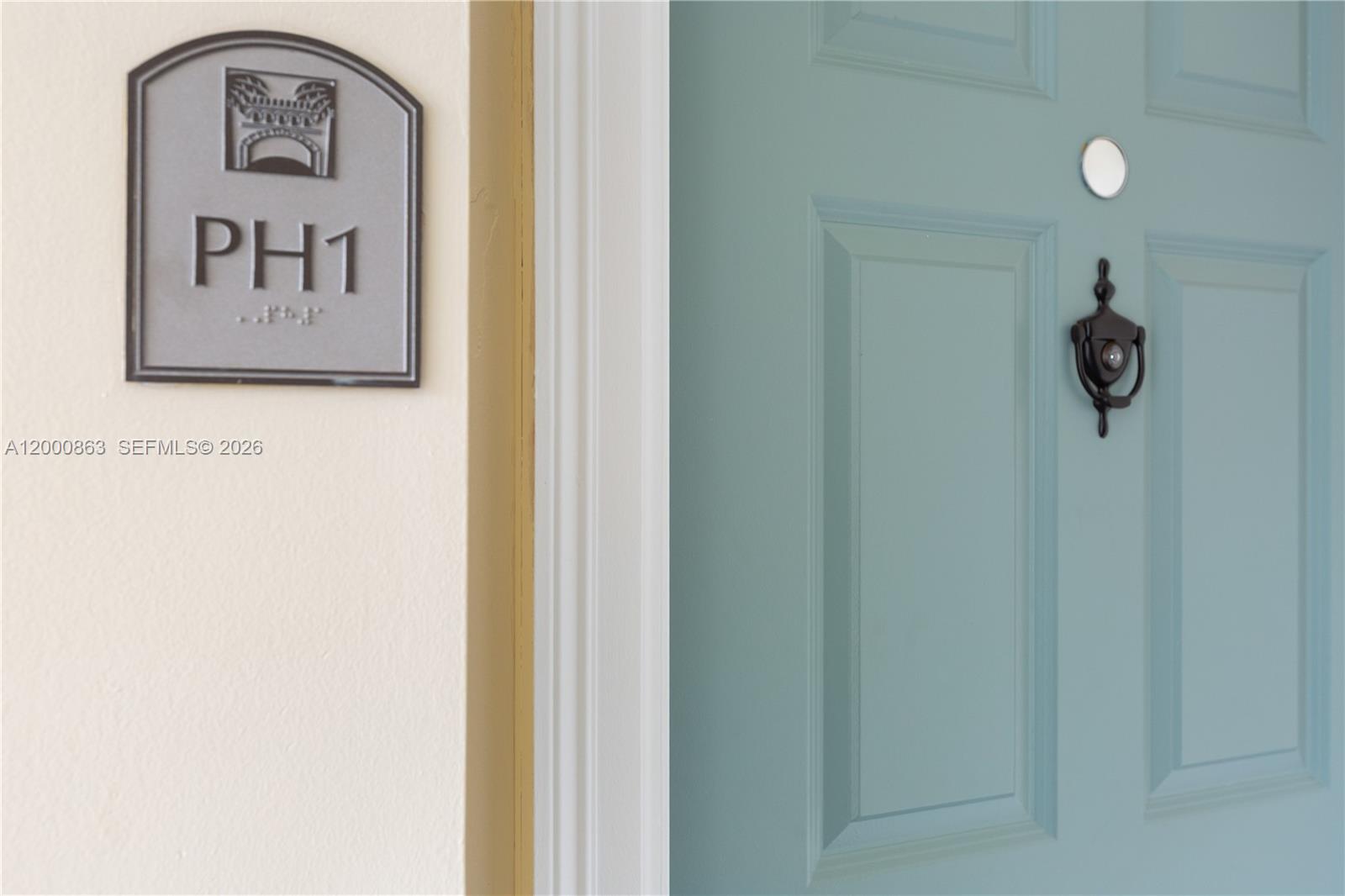 A teal door with a knocker and a sign labeled PH1 on the wall — 888 S Douglas Rd, Coral Gables FL 33134, CORAL GABLES, FL