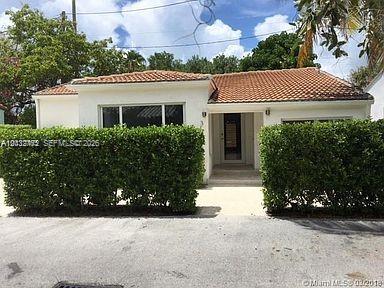 A single-story house with a tiled roof, white exterior, and large hedges in the front — 3 Farrey Ln # 3, Miami Beach FL 33139, MIAMI BEACH, FL