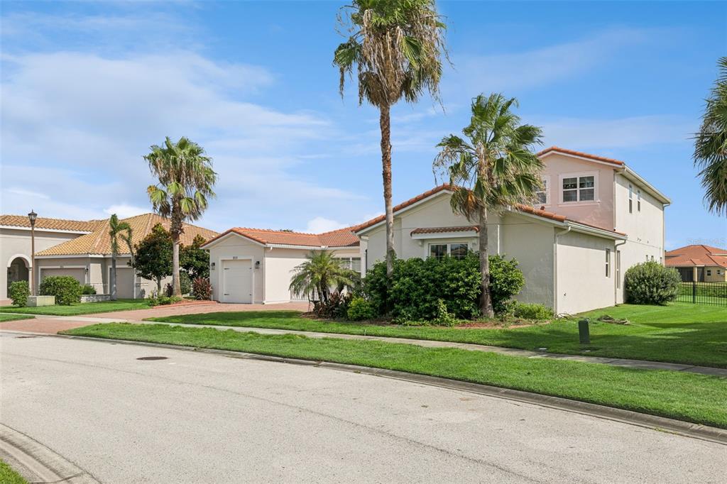 A single-family house with a tiled roof, palm trees, and a paved driveway — 3713 DOCKSIDE DR, KISSIMMEE, FL