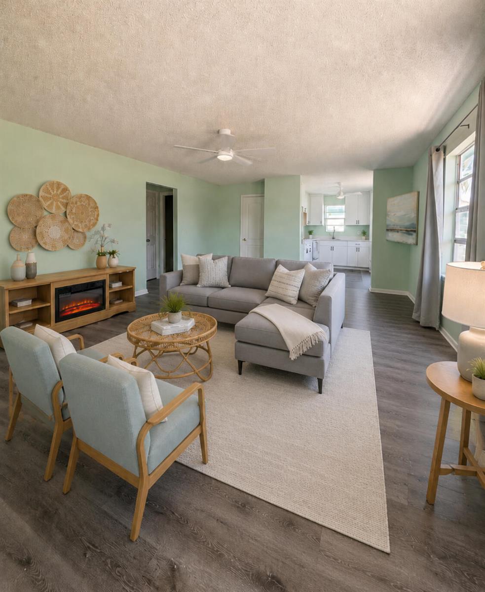 A living room with light green walls, a gray sectional, and an open kitchen beyond — 1328 W 6th Street, Riviera Beach FL 33404, RIVIERA BEACH, FL