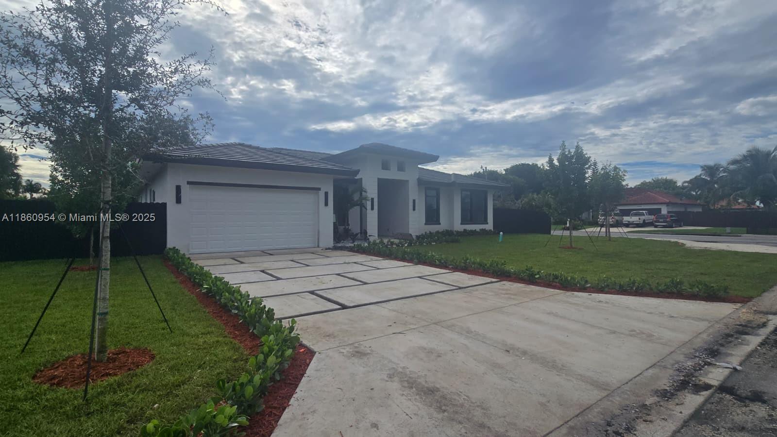 A single-story house with a white exterior, a two-car garage, and a concrete paver driveway — 28361 SW 172nd Ct, Miami FL 33030, MIAMI, FL