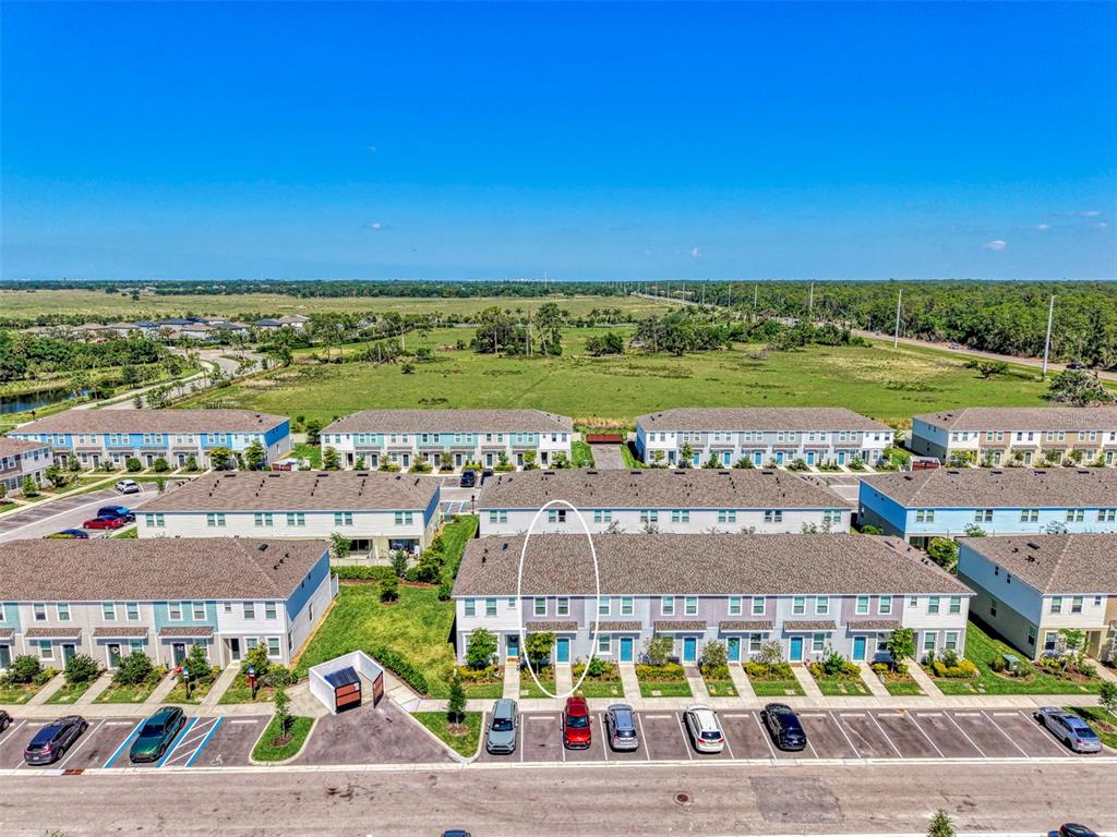 An aerial view of a residential townhouse complex with a highlighted unit — 8540 DAYBREAK STREET, SARASOTA, FL
