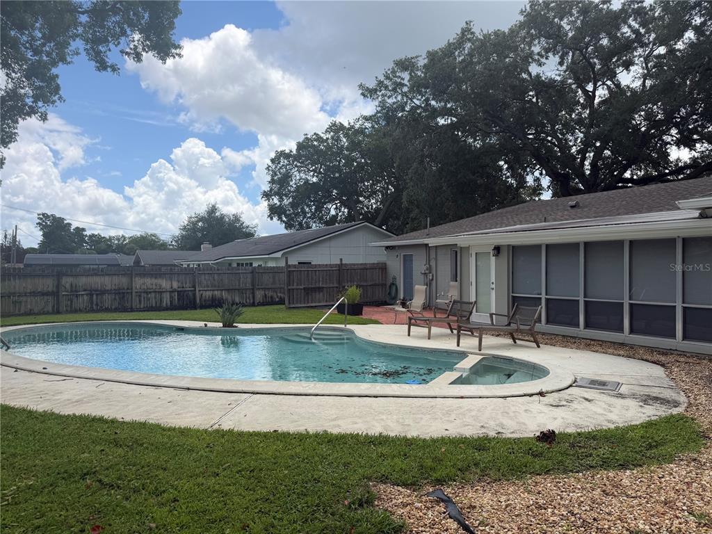 A single-story house with a two-car garage, gray exterior, and a large tree in front — 411 MONTICELLO DRIVE, ALTAMONTE SPRINGS, FL
