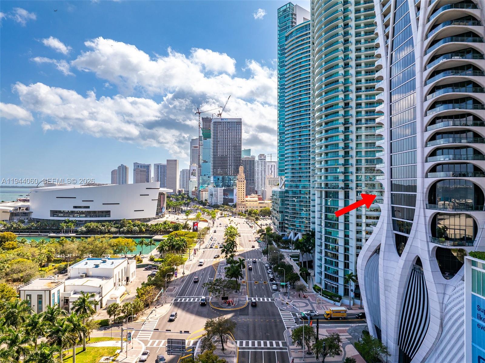 A spacious room with white marble floors, floor-to-ceiling windows, and a balcony overlooking water — 1000 Biscayne Blvd, Miami FL 33132, MIAMI, FL