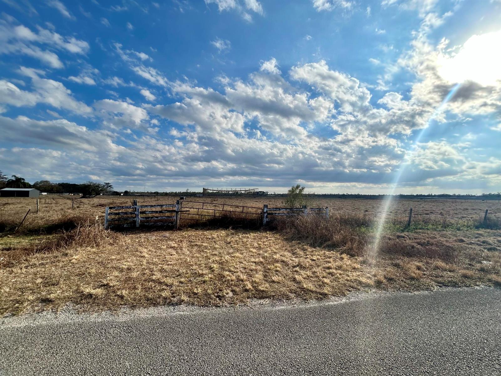 A gravel road leads to a gated entrance of a large, dry, open field — 850 NW 344th Street, Okeechobee FL 34972, OKEECHOBEE, FL