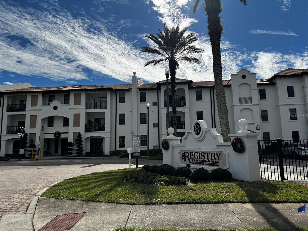 A multi-story apartment complex features a prominent sign for The Registry at Michigan Park — 5550 E MICHIGAN STREET UNIT 2119, ORLANDO, FL