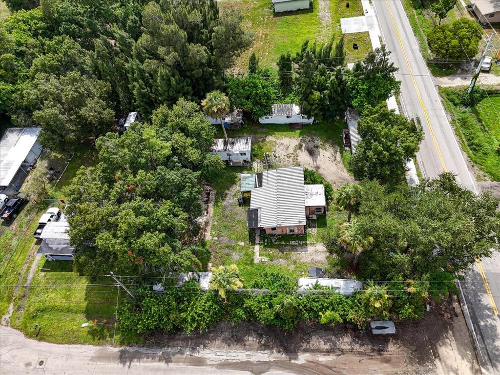 An aerial view shows a residential property with multiple mobile homes and trees — 9890 ORANGE RIVER BOULEVARD, FORT MYERS, FL