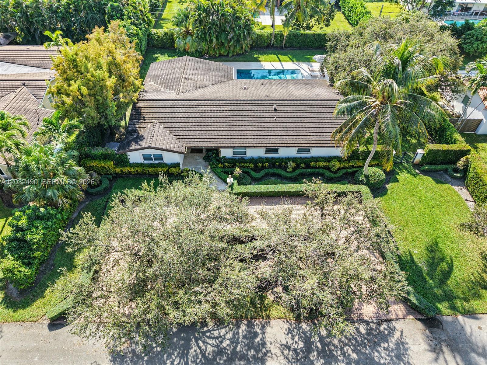 An aerial view shows a single-story house with a tiled roof, pool, and landscaped yard — 7360 SW 115th St, Pinecrest FL 33156, PINECREST, FL