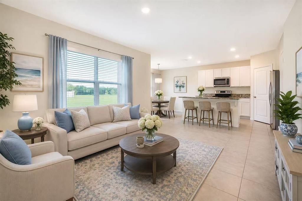 A carpeted staircase leads to an upper level next to a tiled entryway — 30915 PENNY SURF LOOP, WESLEY CHAPEL, FL