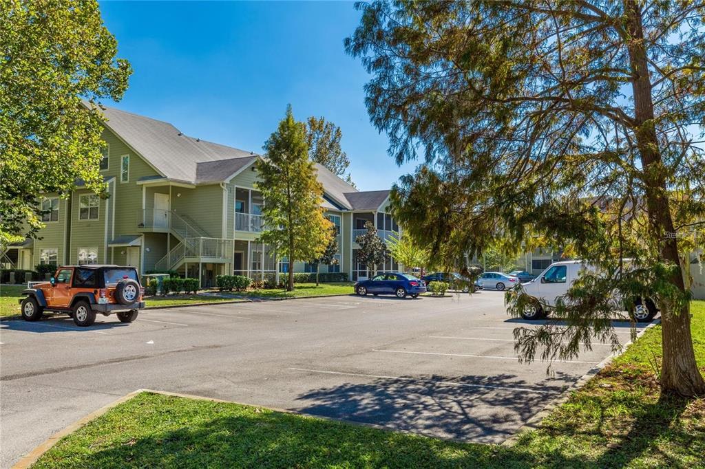 An exterior view of a multi-story apartment building with a parking lot in front — 3725 S LAKE ORLANDO PKWY UNIT 1, ORLANDO, FL