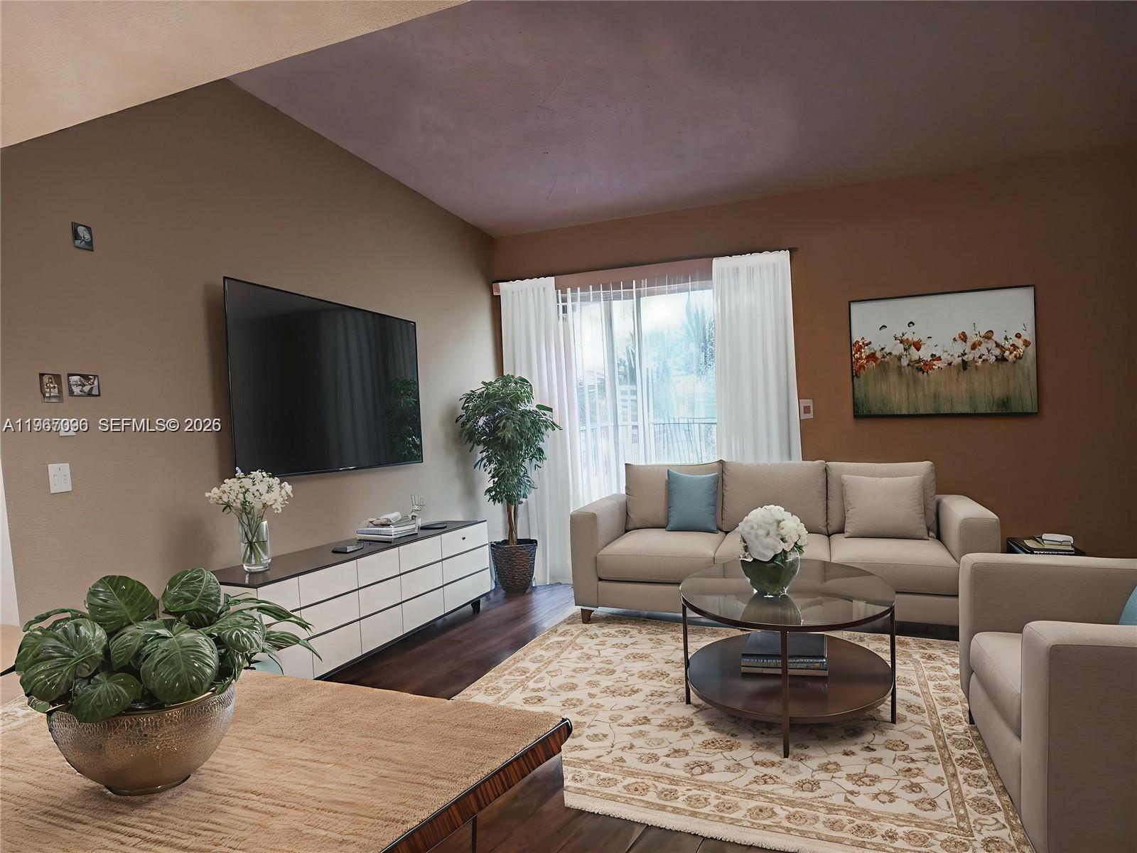 A living room features a beige sofa, a circular coffee table, and a wall-mounted television — 3985 W Mcnab Rd # A302, Pompano Beach FL 33069, POMPANO BEACH, FL