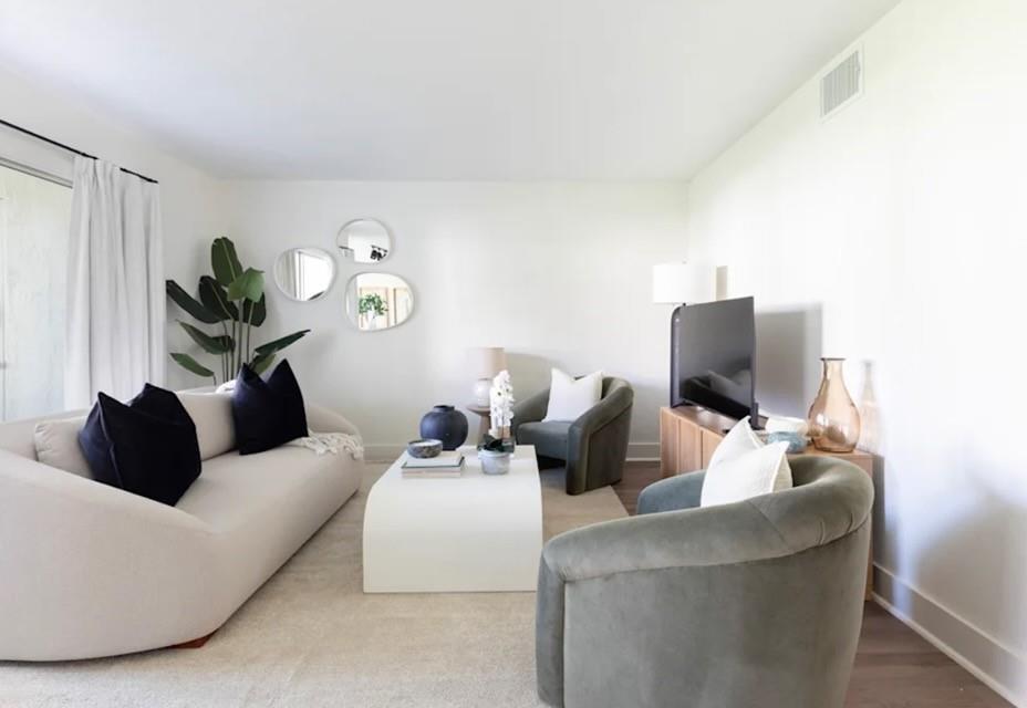 A living room features a curved sofa, two velvet armchairs, a coffee table, and wall mirrors — 800 The Pointe Drive, West Palm Beach FL 33409, WEST PALM BEACH, FL