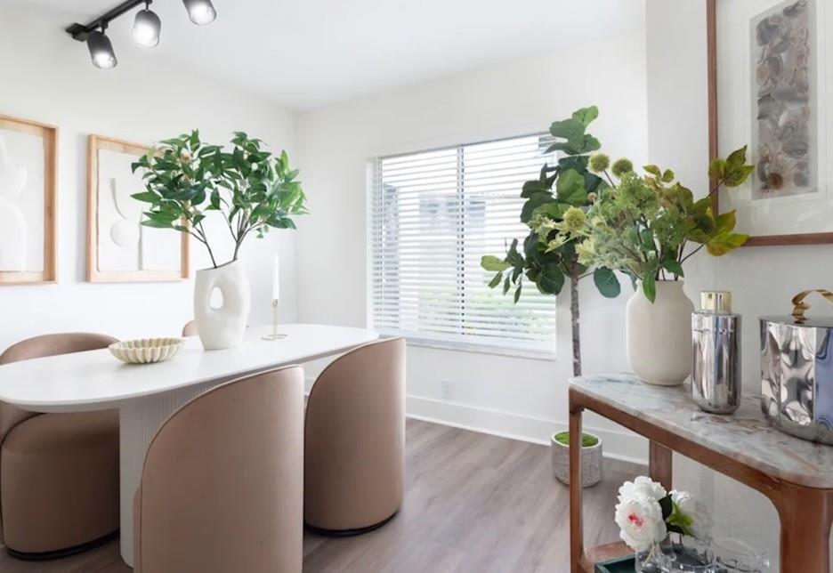 A dining room features a white oval table, beige chairs, and a marble-topped console table — 800 The Pointe Drive, West Palm Beach FL 33409, WEST PALM BEACH, FL