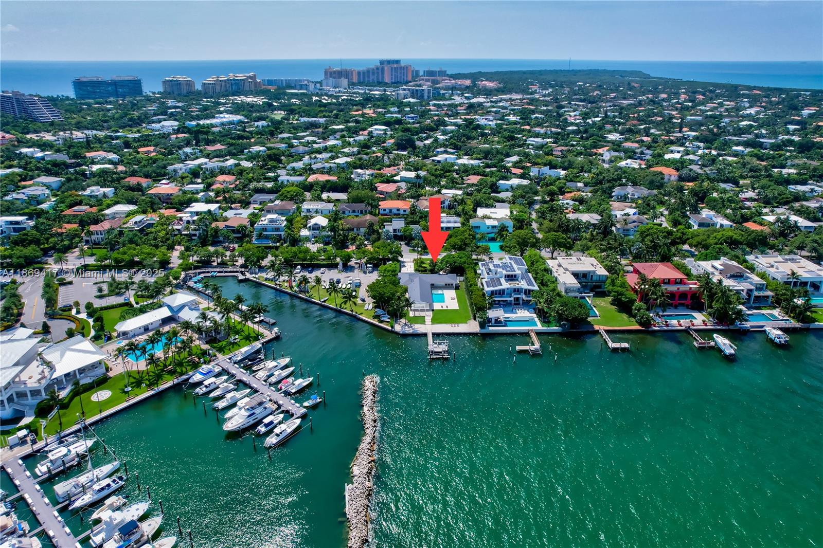 An aerial view shows a waterfront house with a pool and dock in a neighborhood — 200 Harbor Dr, Key Biscayne FL 33149, KEY BISCAYNE, FL