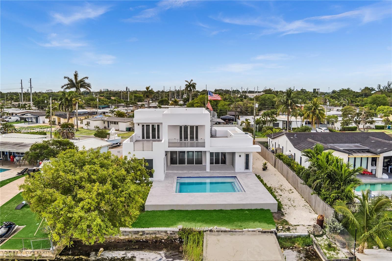 An aerial view of a modern white two-story house with a backyard swimming pool — 10755 SW 52nd Ter, Miami FL 33165, MIAMI, FL