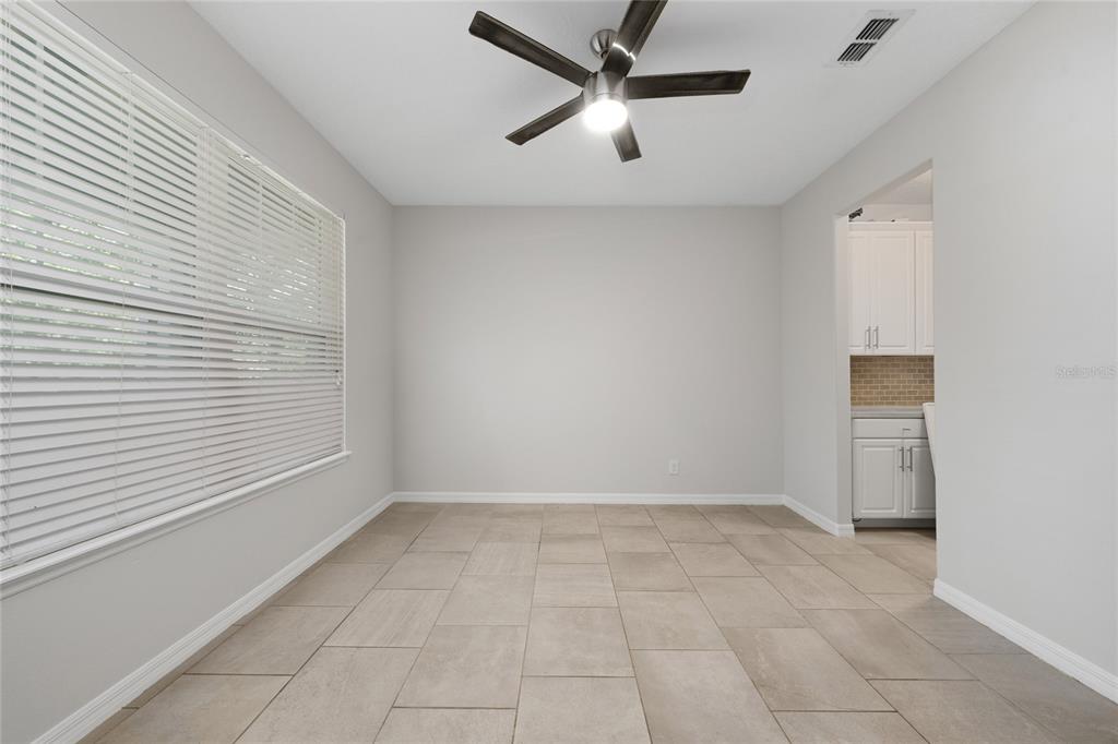 A dining room with light gray walls, tile flooring, a ceiling fan, and window blinds — 8659 VEDDER LANE, ORLANDO, FL