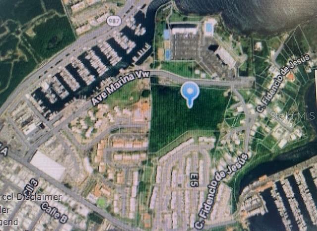 This is an aerial map showing a vacant green lot marked with a blue location pin — NE EAST LAGOON DRIVE DRIVE NE, FAJARDO, PR