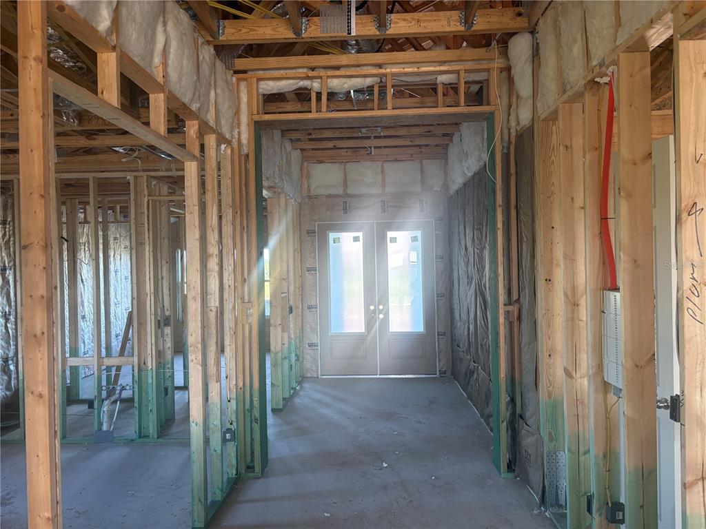 A bathroom features a double vanity with white cabinets, a large mirror, and a glass-enclosed shower — 9806 LEAF GREEN LANE, DADE CITY, FL