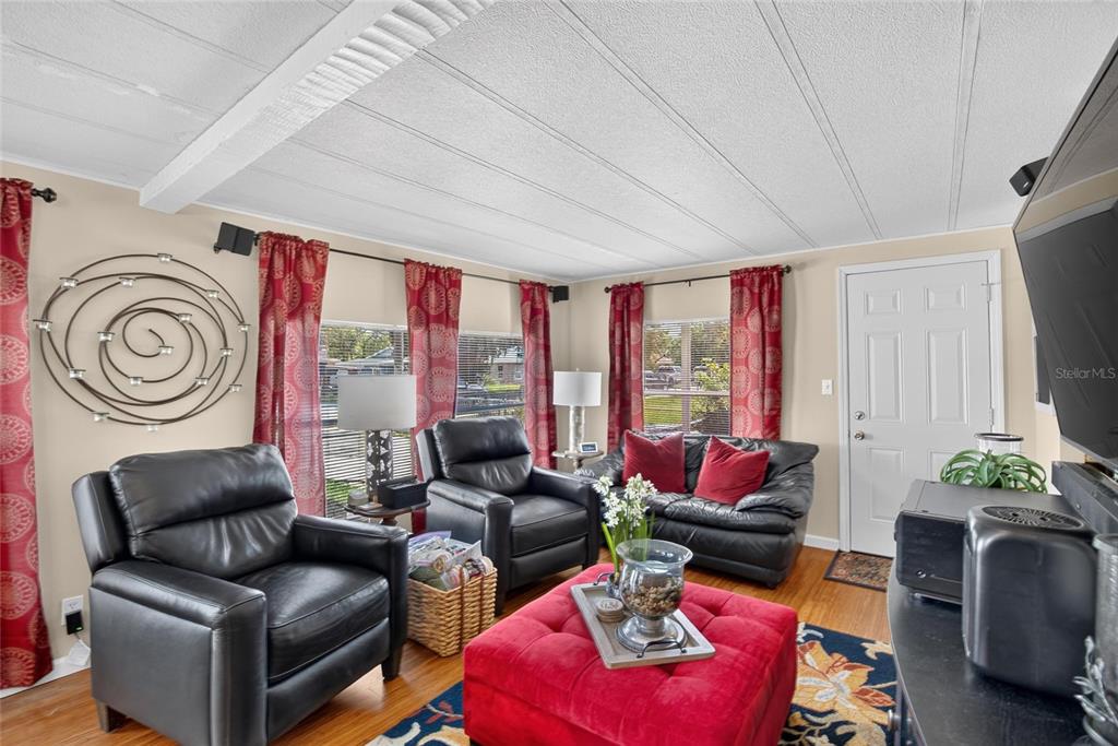 A dining area with a purple tablecloth, wooden chairs, and a black leather armchair nearby — 2715 EATON AVENUE, EATON PARK, FL