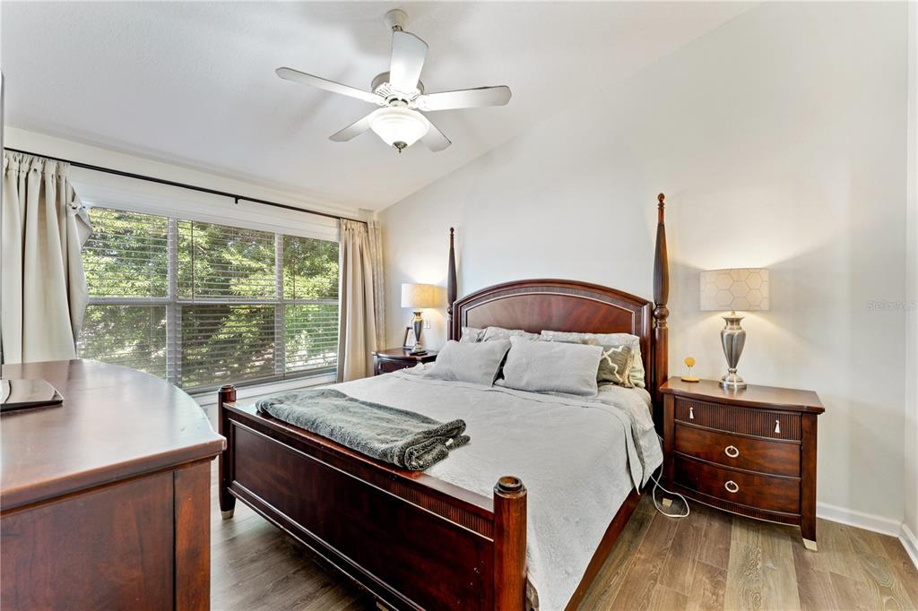 A bedroom features a wooden four-poster bed, two nightstands, and a ceiling fan — 9758 FOX HOLLOW ROAD, TAMPA, FL