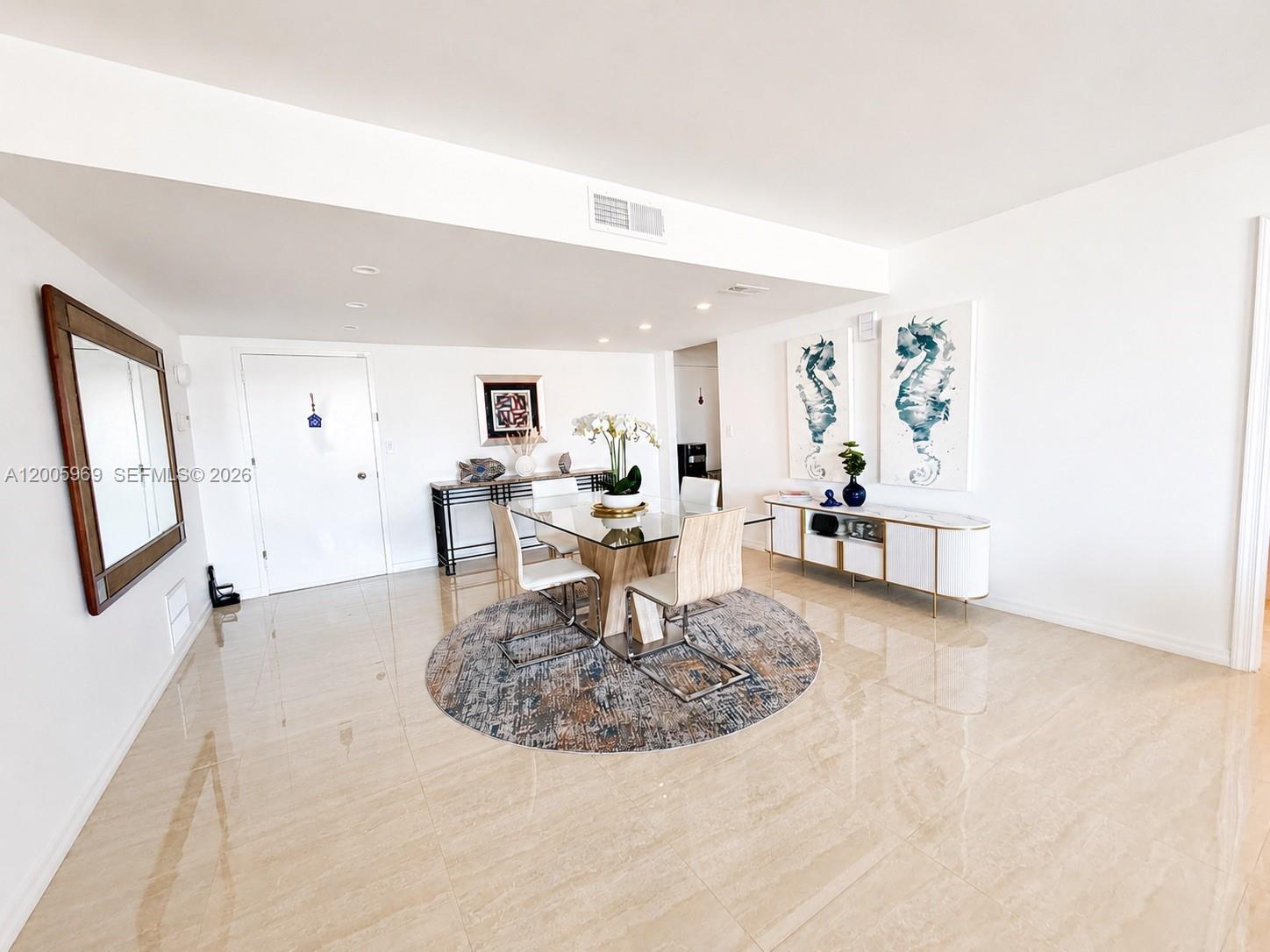 A dining area features a glass table, four chairs, a round rug, and tiled floors — 2773 S Ocean Blvd # 4070, Palm Beach FL 33480, PALM BEACH, FL