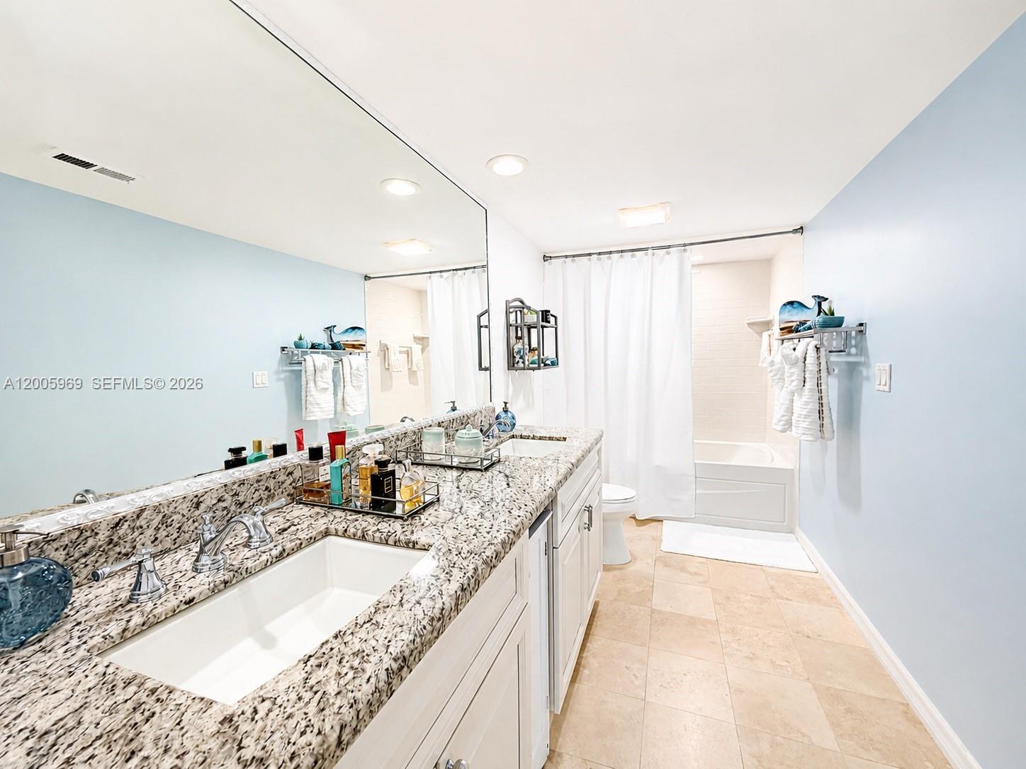 A bathroom features a double vanity with granite countertops, white cabinets, and a shower-tub combo — 2773 S Ocean Blvd # 4070, Palm Beach FL 33480, PALM BEACH, FL