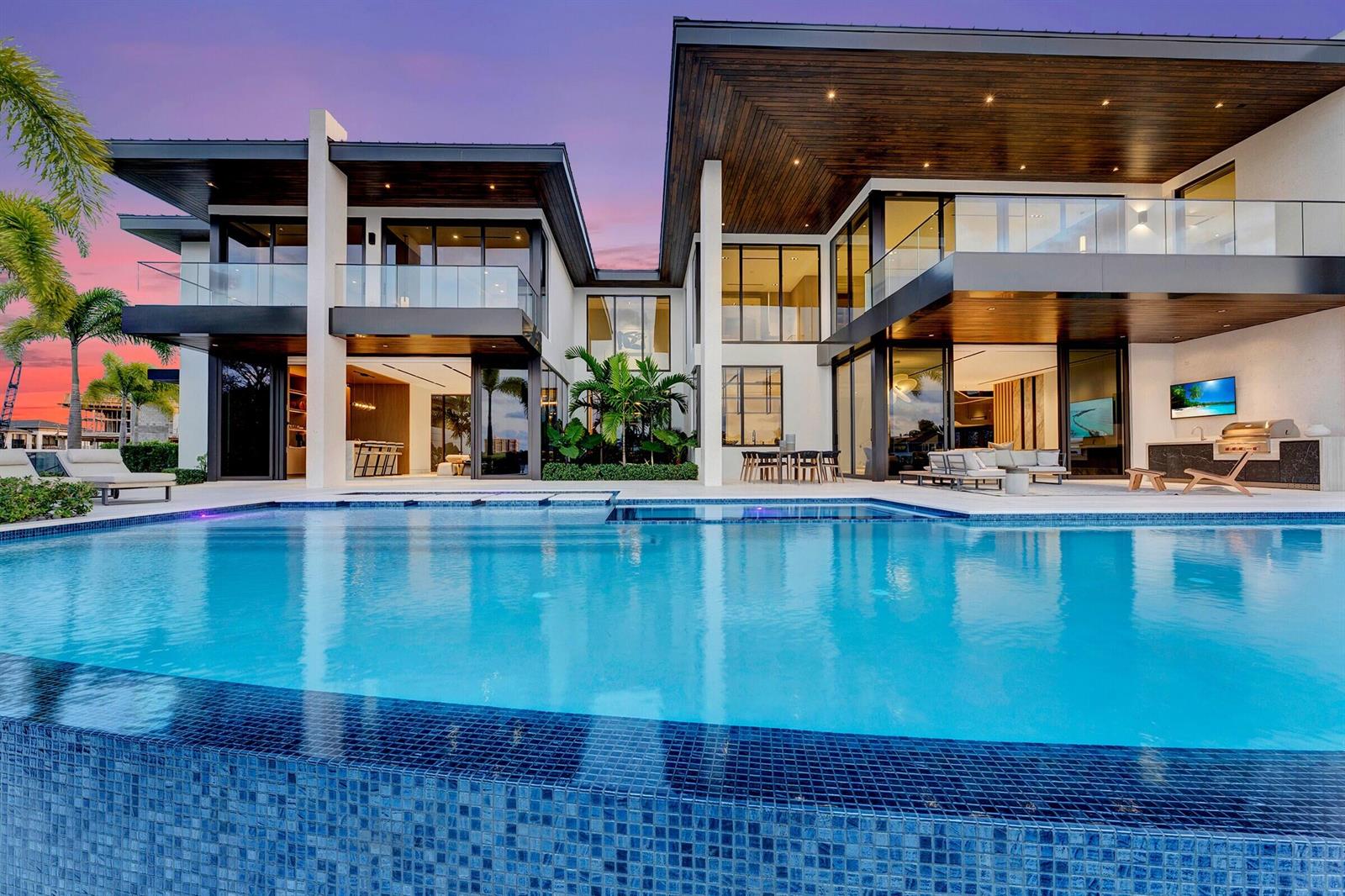 A modern two-story luxury home with a large swimming pool and expansive glass walls — 829 Orchid Drive, Boca Raton FL 33432, BOCA RATON, FL