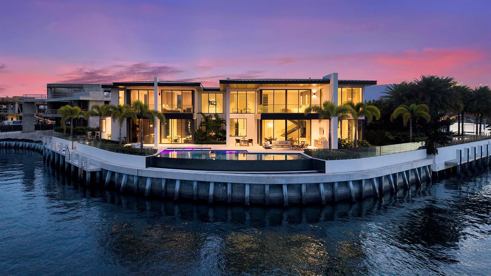 A modern two-story waterfront mansion with a pool and palm trees at sunset — 829 Orchid Drive, Boca Raton FL 33432, BOCA RATON, FL