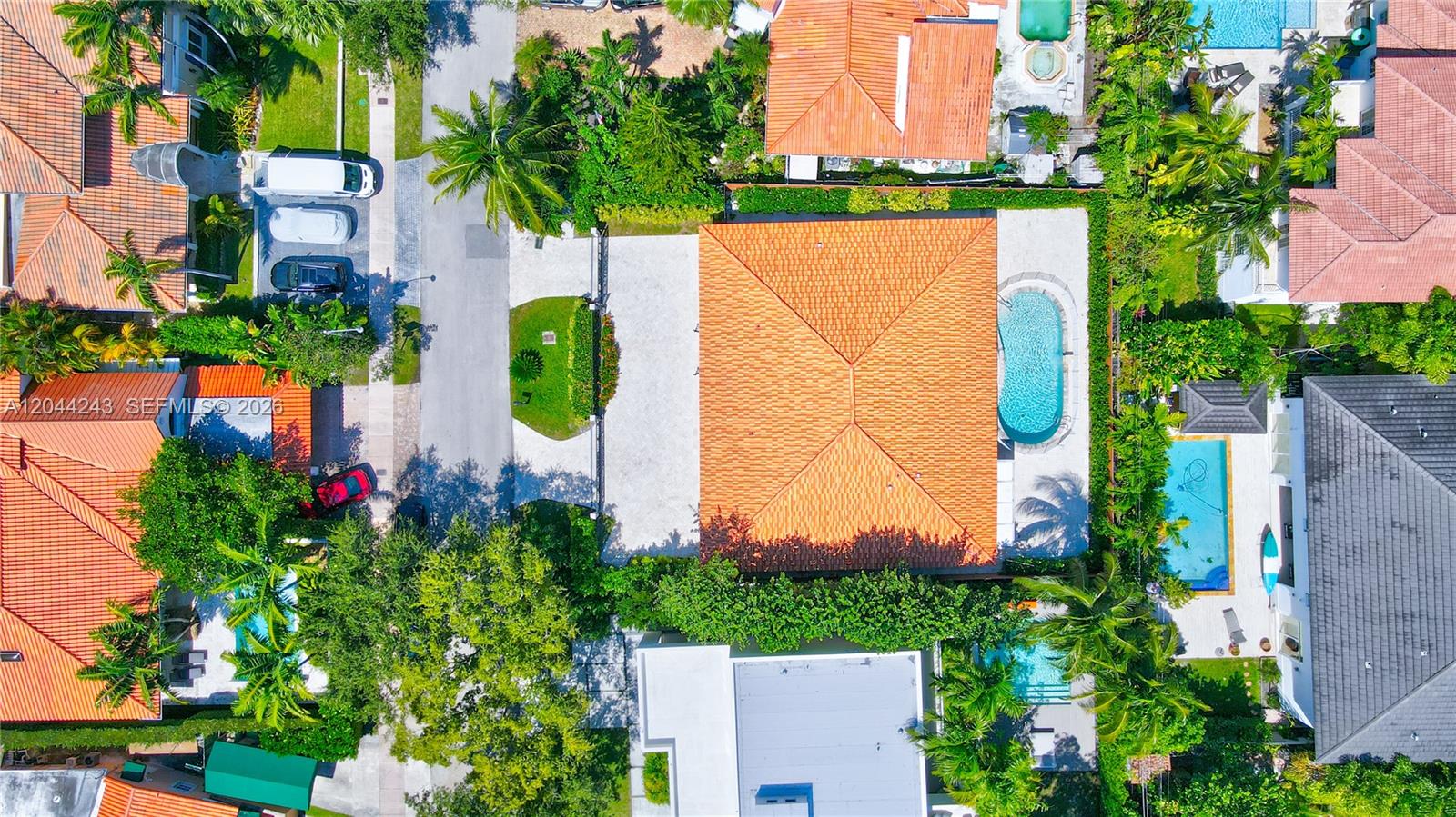 An aerial view shows a residential property with a tiled roof, pool, and surrounding landscaping — 773 Woodcrest Rd, Key Biscayne FL 33149, KEY BISCAYNE, FL