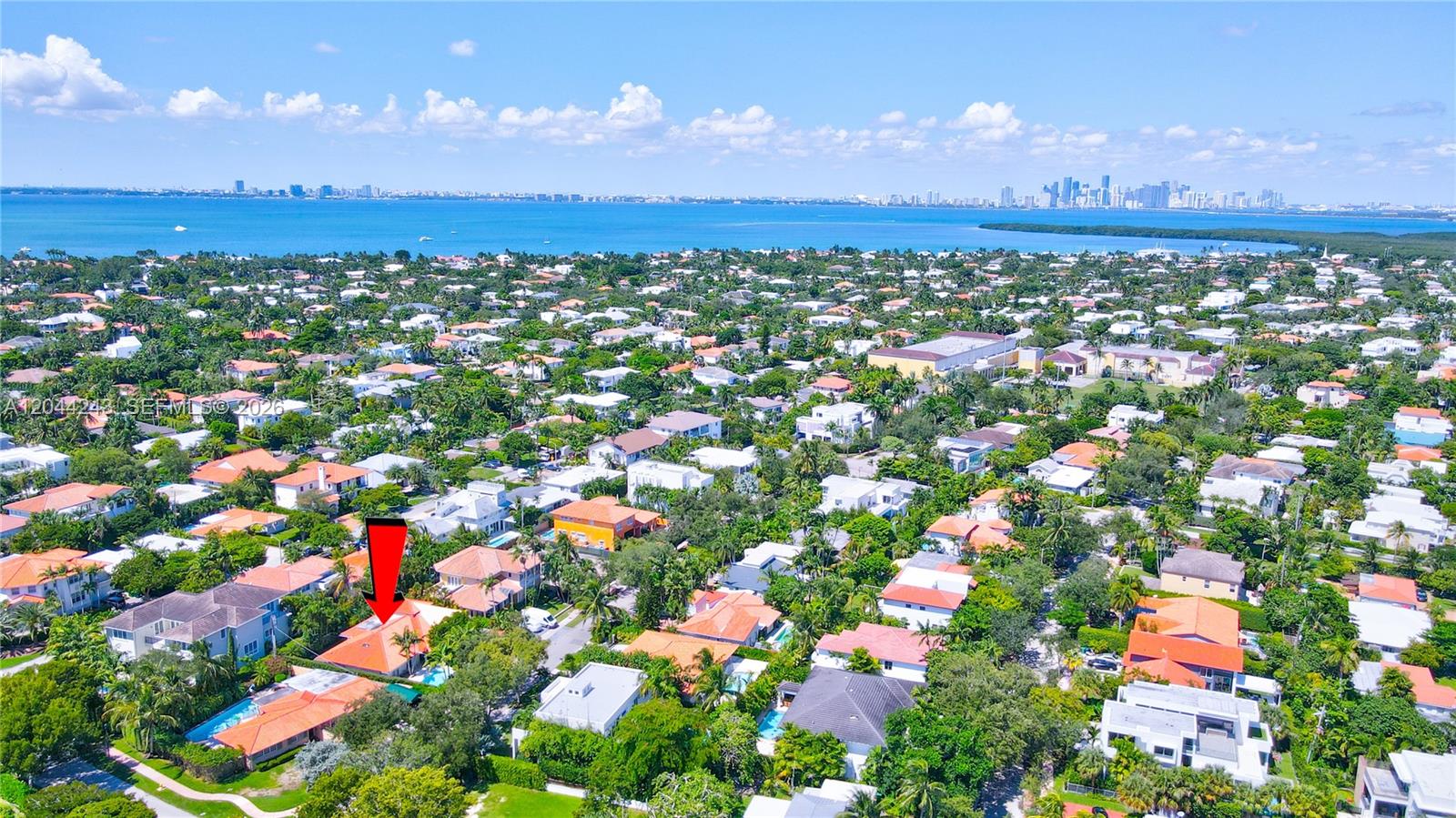 An aerial view shows a residential neighborhood with a red-roofed house marked by an arrow — 773 Woodcrest Rd, Key Biscayne FL 33149, KEY BISCAYNE, FL