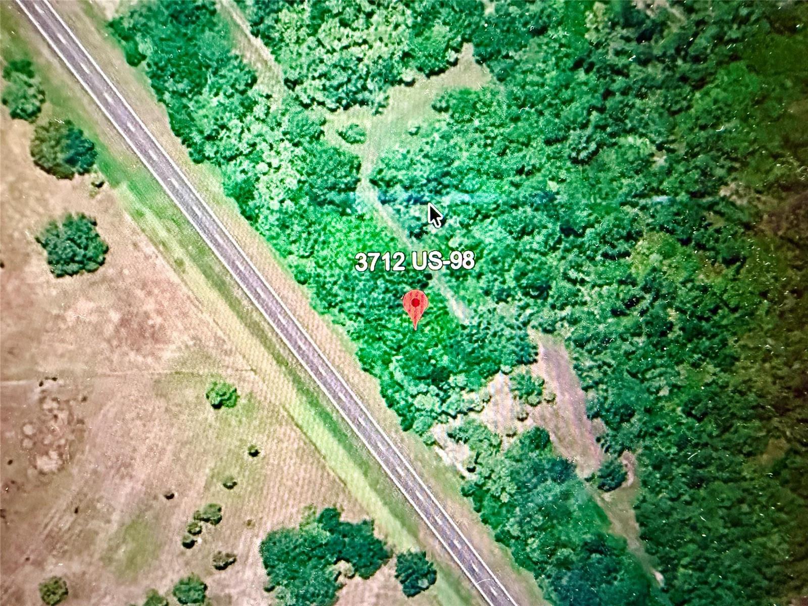 This is an aerial map view showing a wooded lot adjacent to a highway — 3712 N Hwy 98, Okeechobee FL 34972, OKEECHOBEE, FL