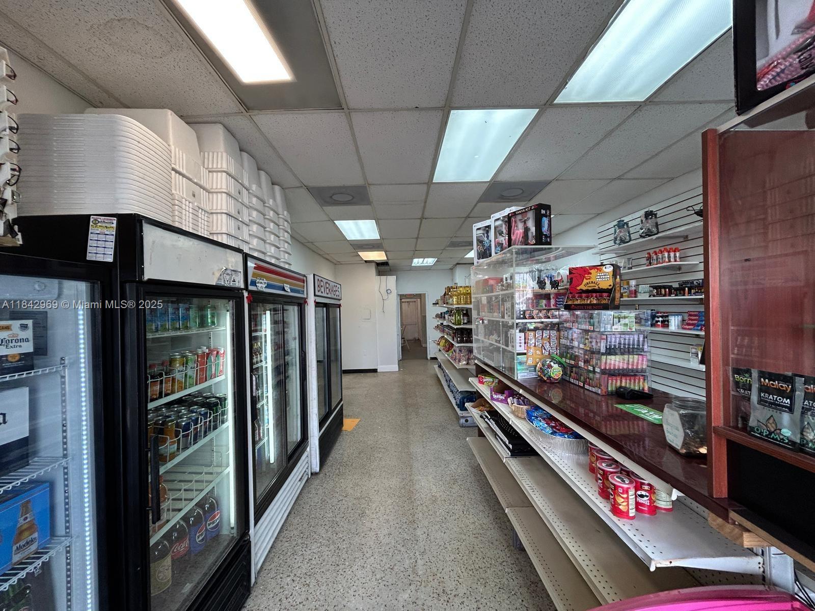 The interior of a small retail store features refrigerated beverage cases and display shelving — 622 E 9th Street, Hialeah FL 33010, HIALEAH, FL
