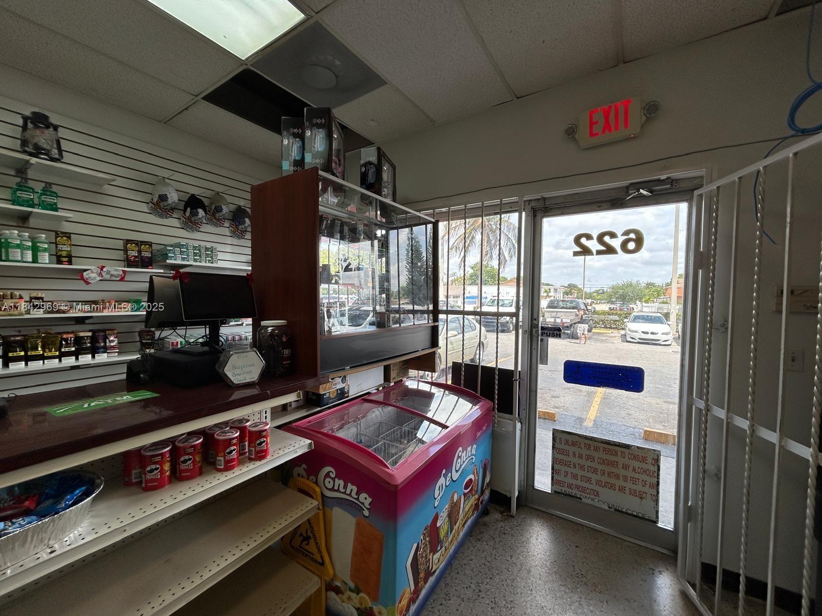 A small retail shop interior features a checkout counter, an ice cream freezer, and shelving — 622 E 9th Street, Hialeah FL 33010, HIALEAH, FL