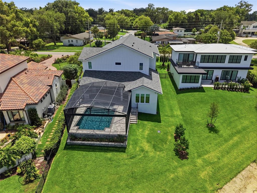 An aerial view shows a two-story house with a screened-in pool and large backyard — 3001 S OSCEOLA AVENUE, ORLANDO, FL