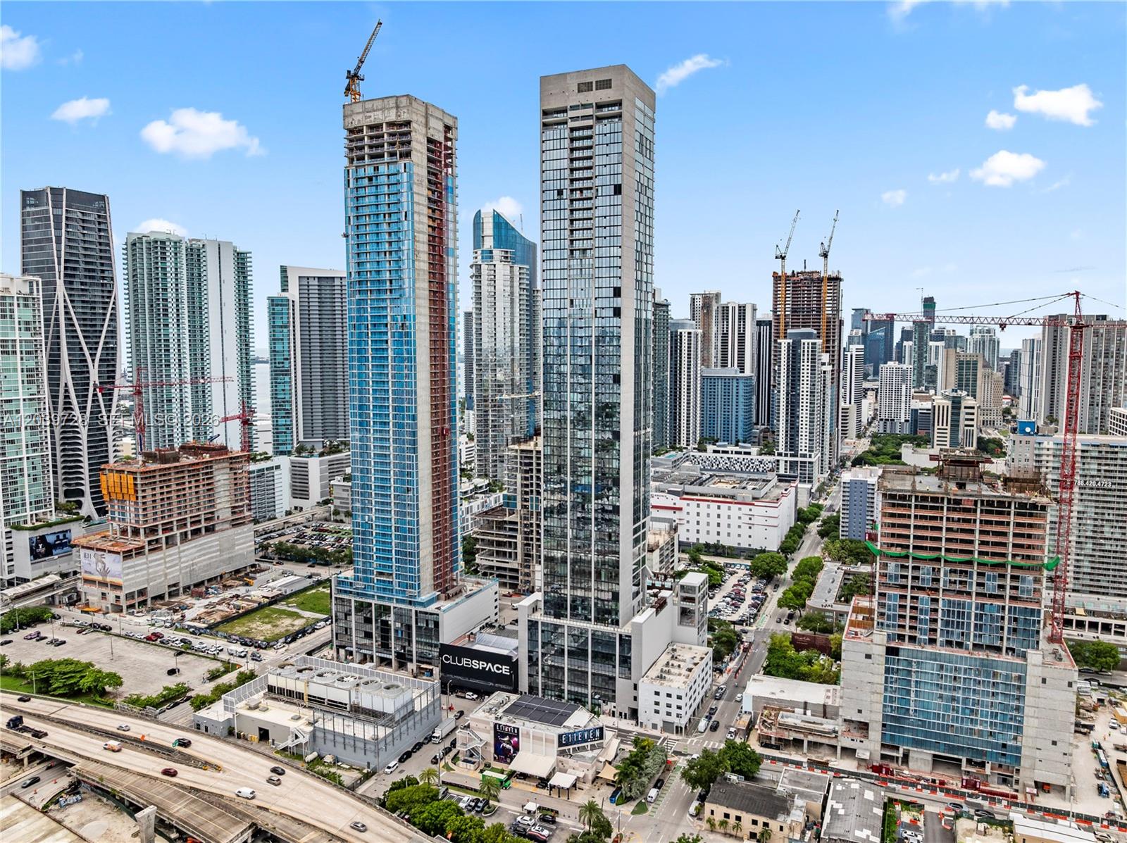 An aerial view shows multiple high-rise buildings and construction sites in a dense urban skyline — 20 NE 11th St # 2211, Miami FL 33132, MIAMI, FL