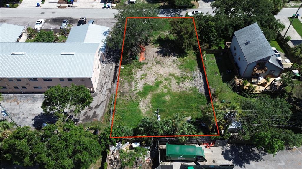 An aerial view shows a rectangular vacant lot outlined in red between two buildings — 4813 W FLAMINGO ROAD, TAMPA, FL